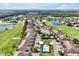 Aerial view of community featuring a golf course, lake, and pool amenities at 168 Club Villas Ln, Kissimmee, FL 34744
