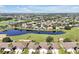 Scenic aerial view of a golf course community, featuring a tranquil lake and lush landscape at 168 Club Villas Ln, Kissimmee, FL 34744