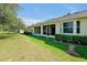 Residential backyard with a lush green lawn and an open view to a golf course at 168 Club Villas Ln, Kissimmee, FL 34744