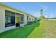 Exterior shot of the backyard featuring a well-manicured lawn next to the golf course at 168 Club Villas Ln, Kissimmee, FL 34744
