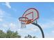 Community basketball hoop with net and court, set against a beautiful blue sky at 168 Club Villas Ln, Kissimmee, FL 34744
