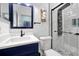 This bathroom showcases a sleek black framed shower and complementary navy blue vanity for a modern aesthetic at 168 Club Villas Ln, Kissimmee, FL 34744