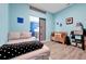 Light blue bedroom features a sliding barn door and a view into the kitchen at 168 Club Villas Ln, Kissimmee, FL 34744
