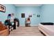Light blue bedroom with desk, decorations, and a bed at 168 Club Villas Ln, Kissimmee, FL 34744