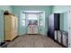 Bedroom showcasing a bay window with an aquarium view, light blue walls, and wood-look flooring at 168 Club Villas Ln, Kissimmee, FL 34744