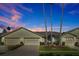 Charming one-story home with well-manicured lawn and three palm trees providing a pleasant, tropical feel at 168 Club Villas Ln, Kissimmee, FL 34744