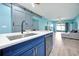 Kitchen island with modern faucet and sink overlooks the spacious living area in this bright and airy home at 168 Club Villas Ln, Kissimmee, FL 34744