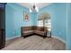 Cozy living area with hardwood floors, a comfortable couch, and natural light creating a relaxing atmosphere at 168 Club Villas Ln, Kissimmee, FL 34744