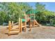 Well-maintained playground with slides and climbing structures, surrounded by lush trees at 168 Club Villas Ln, Kissimmee, FL 34744