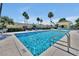 Inviting community swimming pool with clear blue water, lounge chairs, and a charming poolside pavilion at 168 Club Villas Ln, Kissimmee, FL 34744
