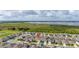 Aerial shot showcasing homes nestled in a community setting near a scenic lake and green space at 176 Sofia Ln, Lake Alfred, FL 33850