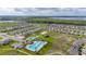 Aerial view of community with pool, playground, and surrounding neighborhood at 176 Sofia Ln, Lake Alfred, FL 33850