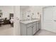 Bright bathroom with a double sink vanity and a view of the connected bedroom at 176 Sofia Ln, Lake Alfred, FL 33850