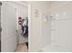 Bathroom with a spacious shower and a view into an organized walk-in closet with plenty of storage at 176 Sofia Ln, Lake Alfred, FL 33850