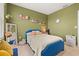 Stylish bedroom with a blue studded bedframe, accent pillows, and charming decor at 176 Sofia Ln, Lake Alfred, FL 33850