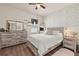 Bright bedroom features rustic wood-look furniture, stylish wallpaper, and a ceiling fan for added comfort at 176 Sofia Ln, Lake Alfred, FL 33850