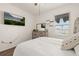 Bedroom with large window, neutral walls, TV and rustic wood dresser at 176 Sofia Ln, Lake Alfred, FL 33850