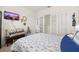 Bedroom with a comfortable bed, decor, and sliding-door closet, providing both style and functionality at 176 Sofia Ln, Lake Alfred, FL 33850