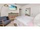 Bright bedroom featuring a large dresser and a flat screen television with a view of the ocean at 176 Sofia Ln, Lake Alfred, FL 33850
