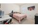 Bedroom featuring a desk, gaming chair, and bed with patterned bedding, ideal for studying or gaming at 176 Sofia Ln, Lake Alfred, FL 33850
