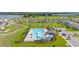 Aerial view highlighting a large community pool, amenities, and landscaped surroundings at 176 Sofia Ln, Lake Alfred, FL 33850