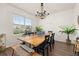 Sun-filled dining room features wood flooring, a large table, a beaded chandelier and modern decor at 176 Sofia Ln, Lake Alfred, FL 33850
