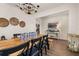 Dining room features a long wood table, black chairs, an elegant chandelier and modern decorations at 176 Sofia Ln, Lake Alfred, FL 33850