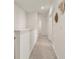 A bright hallway with white walls and carpeted floors leads to other rooms in the home at 176 Sofia Ln, Lake Alfred, FL 33850