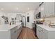 Modern kitchen with gray cabinetry, stainless steel appliances, a large island and hardwood flooring at 176 Sofia Ln, Lake Alfred, FL 33850