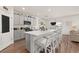 Bright kitchen featuring a large island with seating, stainless appliances, and stylish gray cabinets at 176 Sofia Ln, Lake Alfred, FL 33850