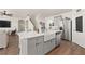 Charming kitchen with a large farmhouse sink, stainless steel appliances, and an island with a white countertop at 176 Sofia Ln, Lake Alfred, FL 33850
