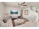 Spacious living room with comfortable seating, a ceiling fan, and a large TV at 176 Sofia Ln, Lake Alfred, FL 33850