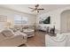 Bright living room featuring comfortable seating, a ceiling fan, and a large TV at 176 Sofia Ln, Lake Alfred, FL 33850