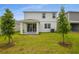 Exterior of home features white siding, manicured lawn and covered patio at 208 Flag Lilly Ln, Umatilla, FL 32784