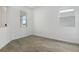 Bright, empty room with tile floors and two windows, ready for personalization at 208 Flag Lilly Ln, Umatilla, FL 32784
