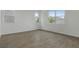 Bright and airy empty room with neutral tile flooring and multiple windows at 208 Flag Lilly Ln, Umatilla, FL 32784