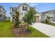 Attractive two-story home with a two-car garage and freshly planted trees at 208 Flag Lilly Ln, Umatilla, FL 32784