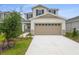 Charming two-story home with a two-car garage and well-maintained landscaping at 208 Flag Lilly Ln, Umatilla, FL 32784