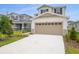 Beautiful two-story home with a wide driveway and manicured front yard at 208 Flag Lilly Ln, Umatilla, FL 32784