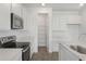 Well-lit kitchen with white cabinetry, stainless steel appliances, and a walk-in pantry at 208 Flag Lilly Ln, Umatilla, FL 32784