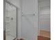 Clean and well-lit bathroom featuring a glass-enclosed shower and a view to the walk-in closet at 212 Flag Lilly Ln, Umatilla, FL 32784