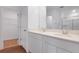 Modern bathroom with double sinks, white cabinets, and a spacious shower area at 212 Flag Lilly Ln, Umatilla, FL 32784
