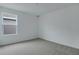 Neutral bedroom with carpeted flooring and a window, ready for personalization at 212 Flag Lilly Ln, Umatilla, FL 32784