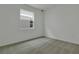 Bedroom with neutral carpet, white walls, and a large window at 212 Flag Lilly Ln, Umatilla, FL 32784