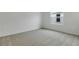 Comfortable bedroom with neutral carpet and a bright window for natural light at 212 Flag Lilly Ln, Umatilla, FL 32784