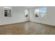 Bright bedroom with beautiful wood-look flooring and natural light from large windows at 212 Flag Lilly Ln, Umatilla, FL 32784
