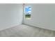 Bright bedroom with neutral carpet, large window, and beautiful scenic outdoor views at 212 Flag Lilly Ln, Umatilla, FL 32784