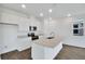 Bright kitchen featuring white cabinetry, stainless steel appliances, and a center island at 212 Flag Lilly Ln, Umatilla, FL 32784
