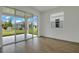 Open living room featuring sliding glass doors to the outdoor patio and wood-look flooring at 212 Flag Lilly Ln, Umatilla, FL 32784