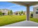 Backyard with grass and view of a patio at 216 Flag Lilly Ln, Umatilla, FL 32784